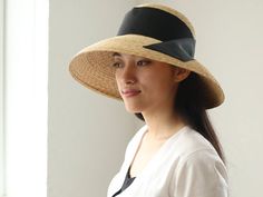 "I just adore classic movie stars wearing their hats so elegantly. This Casablanca style hat, \" Holly\", is inspired by those classic movies, and also added modernity for today. The wide brim is nicely curved to the end, covers perfectly your face from sunshine. Material is natural, narrow good quality straw, which you hardly find in mass products nowadays. Please chose ribbon colour black, white, beige and grey. I attached the ribbon to the side by sewing. If you wish to show in the front or b Elegant Straw Visor Hat, Elegant Boater Hat With Visor For Spring, Elegant Spring Boater Hat With Visor, Elegant Visor Boater Hat For Vacation, Elegant Boater Hat With Visor For Vacation, Elegant Visor Sun Hat For Kentucky Derby, Elegant Summer Panama Visor Hat, Elegant Visor Sun Hat For The Kentucky Derby, Elegant Adjustable Panama Visor Hat