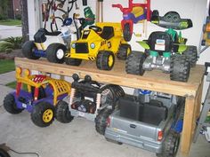 toy trucks and tractors are lined up on a shelf in a garage with other toys