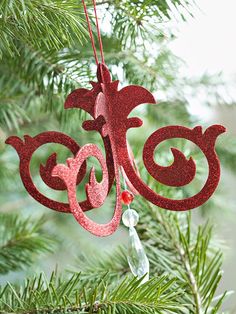 a red ornament hanging from a christmas tree