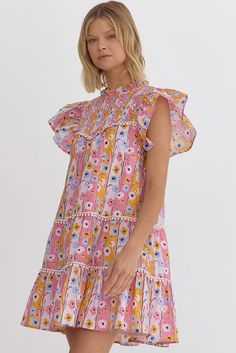 Dive into the colors of spring with our vibrant Watercolor Floral Ruffle Sleeve Dress. Perfect for any sunny day outing, this dress features a lively floral pattern in a spectrum of pinks, yellows, and blues set against a soft peach background. The playful hues are reminiscent of a painter's brush strokes, making it a walking piece of art. Perfect for a gender reveal, baby shower, and more. SIZE & FIT Fit is true to size Model is 5'9" wearing size small FABRIC & CARE 100% Cotton Self 100% Polyester Lining Hand wash cold Line dry DETAILS Lightweight and breathable fabric ideal for warm weather, ensuring comfort without sacrificing style. This charming dress boasts a tiered structure that adds volume and movement. Each tier is separated by delicate lace trims that enhance its feminine appeal Black Date Night Outfit, Peach Background, Nashville Style, Ruffle Sleeve Dress, Floral Ruffle, Bride Accessories, Playsuit Romper, Flutter Sleeve Dress, Summer Knitting