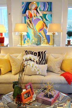 a living room filled with lots of furniture and decor on top of a checkered floor