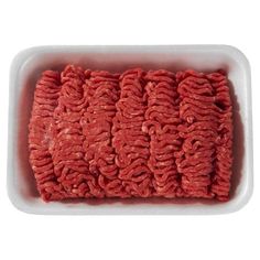 raw ground beef in a white dish on a white background with clippings to the side