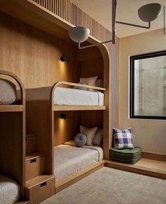 the bunk beds in this room are made out of wood and have lights on them