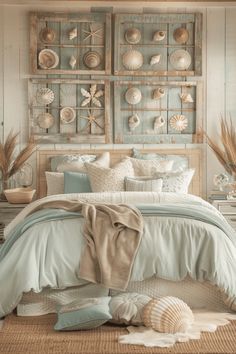 a bed room with a neatly made bed and sea shells on the wall above it