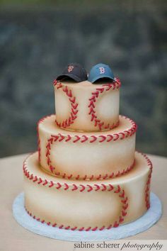 a three tiered cake with baseball themed frosting