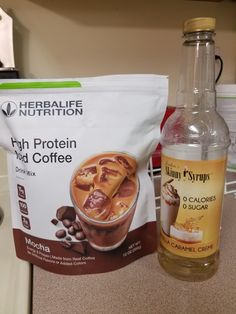 a bag of protein drink next to a bottle of coffee on a kitchen counter top