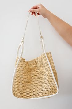 Explore your own style with the Road Less Traveled Handbag! This striking and unique woven straw shoulder bag is paired with a matching faux leather zipper tote, providing both fashion and function. With a vegan leather handle, snap closure, and timeless design, this bag allows you to express yourself in a bold and stylish way! Open Weave Enforced Straw Faux Leather Snap Closure Adjustable Handle Zippered Removable Pouch 12”W X 10.5” H X 4”D Adjustable Shoulder Strap 26.5-28” Envelope Zipper Pou Cream Hobo Bag With Top Handle And Removable Pouch, Cream Double Handle Bag With Zipper, Eco-friendly Shoulder Bag With Braided Handles For Daily Use, Eco-friendly Straw Bag With Top Handle And Adjustable Strap, Cream Double Handle Bag With Zipper Closure, Open Weave, Zippered Tote, Leather Zipper, Leather Handle