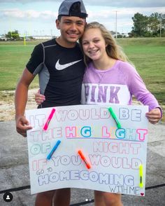 two young people standing next to each other holding a sign that says think it would be the highlight of what you would be doing