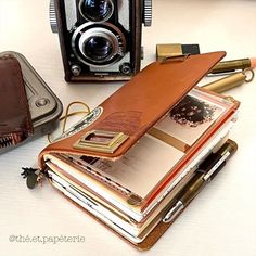 an old camera and some books on a table