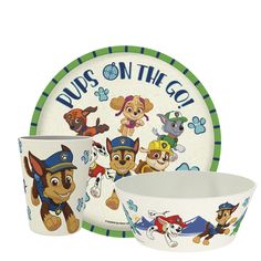 the paw patrol dinnerware set includes two cups and one bowl, along with an image of pups on the go