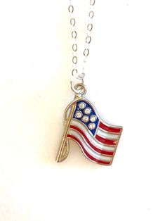 Beautiful red and blue enameled American flag charm with rhinestone stars hangs on delicate sterling silver necklace. One-sided wavy American flag is 24 x 17mm USA made high quality pewter with tiny sparkling rhinestone crystal stars. Flag hangs from delicate .925 sterling silver cable chain with spring ring clasp. Matching bracelet and earrings also available in my shop. This listing is for one USA flag necklace only. Paris Charm Bracelet, Flag Hanging, Patriotic Jewelry, Love America, Personalized Quilt, Crystal Stars, Matching Bracelet, Usa Flag, Cable Chain