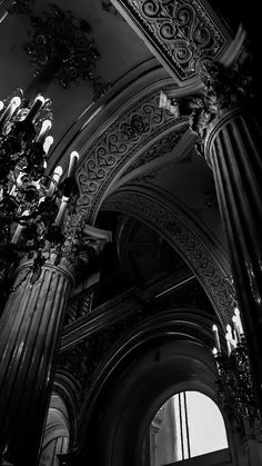 an ornate building with columns and chandelier in the center, black and white photograph