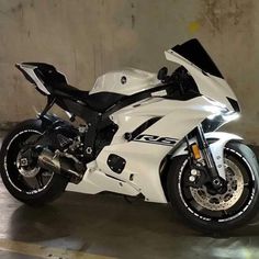 a white and black motorcycle parked in a garage