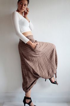 "Beautiful double layer fabric made of cotton/linen blend. High quality and stunning beauty. The fabric is unbleached and undyed, you can see the bark fibres in it! Subtle stripe pattern Drop-crotch style pants, baggy pants, tribal pants with a twist. 3 ways to wear. with drawstring on the hem. You can wear it with drawstring loose. Like a wide leg pants. Even look like A shape sweet skirt. You can also draw the string and get a balloon shape pants. Or...you can put the hem above your knee and g Beige Cotton Harem Pants For Fall, Fall Beige Cotton Harem Pants, Cotton Harem Pants For Fall, Fall Cotton Harem Pants, Brown Cotton Harem Pants For Fall, Brown Cotton Ankle-length Harem Pants, Cotton Harem Pants For Fall Festival, Bohemian Brown Cotton Pants, Beige Baggy Cotton Harem Pants