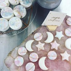 moon and stars cookies are on display at the dessert table for guests to enjoy them