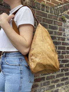 1st Classe signature brown toned map print bag made in the late 90s early 00s.  Plastic man made body with tan leather trim and a canvas and leather strap.  The strap is adjustable slightly from 66 - 74 cm. Has a zipped compartment on the front and a leather badge embossed with the brands name.   Theres one compartment inside which you access from the back of the bag by a zip. Theres no lining just the reverse of the other manmade fabric. Theres another leather badge inside embossed with the bra Retro Leather Backpack With Adjustable Strap, Vintage Beige Coated Canvas Shoulder Bag, Vintage Light Brown Shoulder Bag With Adjustable Strap, Vintage Bags In Coated Canvas With Adjustable Strap, Vintage Bag With Adjustable Strap In Coated Canvas, Vintage Coated Canvas Shoulder Bag For Travel, Vintage Coated Canvas Bag With Adjustable Strap, Vintage Coated Canvas Satchel For Everyday, Vintage Leather Backpack With Adjustable Strap For Adventure