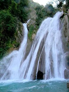 there is a large waterfall that has water cascading down it's sides