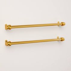 two gold colored handles on white background