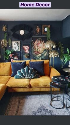 a living room with yellow couches and pictures on the wall above them, along with a coffee table