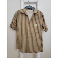 Men's Woven Shirt Button Up In Striped Tan. Short Sleeve Beige Short Sleeve T-Shirt Brand New. Never Worn. See Photos For Fabric And Care Size Medium New With Tag #R0443 Casual Brown Short Sleeve Shirt With Buttons, Casual Brown Camp Shirt With Button Closure, Casual Striped Shirt With Buttons, Casual Brown Button-up Camp Shirt, Striped Camp Collar Top With Button Closure, Brown Button-up Short Sleeve Shirt, Retro Beige Button-up Shirt, Brown Button-up Shirt With Buttoned Pockets, Brown Slim Fit Button-up Shirt