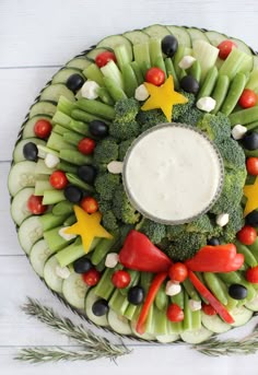 a platter filled with vegetables and dip