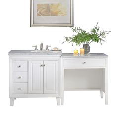 a white bathroom vanity with two sinks and a framed picture above it on the wall