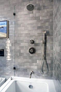 a white bath tub sitting next to a shower head