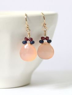 Soft, pretty and just the right length: rose quartz earrings with navy quartz and garnet accents. Shown suspended from gold filled earwires, also available in sterling silver. Dainty teardrop shape flatters and the colors are wear-with-everything. These make a unique work accessory or wfh jewelry to make her feel put together. Blush pink is a very flattering color, set off by darker navy and sparkly purple amethyst. 1.25 inches long; choose gold filled or sterling silver at the drop down menu. Pink Jewelry With Matching Earrings For Birthday, Pink Drop Earrings For Birthday, Pink Birthstone Drop Earrings, Pink Earrings With Lever Back For Anniversary, Pink Lever Back Earrings For Anniversary, Elegant Pink Earrings For Birthday, Elegant Pink Jewelry For Birthday, Elegant Birthstone Earrings For Birthday, Blush Pink Earrings