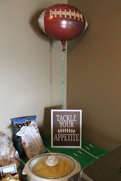 a football balloon and some snacks on a table