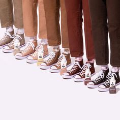 five pairs of converse shoes lined up in a row