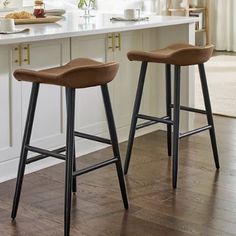 two bar stools sitting on top of a kitchen counter