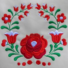 an embroidered red flower with green leaves on white leather background stock images and royalty photos