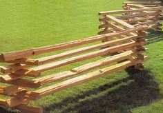 a wooden bench sitting on top of a lush green field