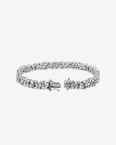 Our Classic Diamond Midi Sparkler Tennis Bracelet is a true masterpiece, designed to dazzle. Expertly handcrafted in 18-karat gold and set with an 6.20 carats of baguette and round white diamonds, this bracelet is the epitome of luxury and elegance. Details 18k white gold 6.20 carats of baguette white diamonds Bracelet measures 7" inches in length Box clasp with safety lock fastening 7mm width Ref: AKB303 Diamonds Bracelet, Timeless Jewelry, Baguette Diamond, White Diamonds, Tennis Bracelet, White Diamond, Diamond White, Diamond Bracelet, Jewelry Pieces