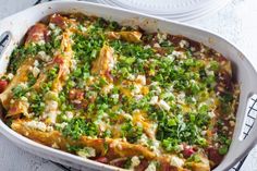 a casserole dish with vegetables and cheese in it