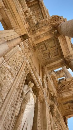 an ancient building with statues on the sides