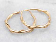 Gold hoops are an essential item in any jewelry collection! These beauties are crafted from 18-karat gold and have a twisted design that catches the light beautifully. Big enough to make a statement, these hoop earrings are also lightweight and perfect for everyday wear. Metal: 18K Yellow GoldMeasurements: 4 x 28 mmMarks: "750 *787" Stamped on the finding Twisted Gold Plated Yellow Gold Hoop Earrings, Gold Plated Hoop Earrings With A Modern Twist, Twisted Yellow Gold Hoop Earrings, Tarnish Resistant, Twisted 14k Yellow Gold Hoop Earrings, Yellow Gold Hoop Earrings With A Modern Twist, Modern Twist Yellow Gold Hoop Earrings, Modern Twist Small Hoop Earrings In Yellow Gold, Yellow Gold Round Earrings With A Modern Twist, Modern Twist Yellow Gold Small Hoop Earrings