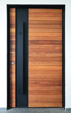 a wooden door with a black handle on the front and side panels that are made out of wood