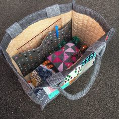 a bag filled with lots of different types of fabric