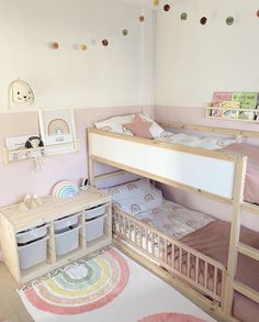 a child's bedroom with two bunk beds and a rug on the floor in front of it