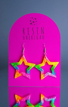 A pair of handmade glittery resin earrings, designed to make you look & feel extra. Playful, eye-catching and vibrant, perfect for festivals, parties, special occasions or just to add a touch of sparkle to your everyday look.  Each pair is meticulously crafted with love and attention to detail, ensuring that you receive a unique piece of jewellery that will make you shine.  A combination of high-quality resin and carefully selected glitters creates a mesmerising effect that catches the light and captures attention. ~ RAINBOW STAR ~ Dimensions - w3.8 x h3.8cm.  Silver plated fish-hook style earrings. Designed and hand crafted from my home studio in Bedfordshire, UK. All jewellery is made to order. Thanks for looking! x Multicolor Heart-shaped Festival Jewelry, Multicolor Glitter Drop Earrings, Multicolor Star-shaped Party Earrings, Heart-shaped Rainbow Earrings As Gift, Fun Multicolor Resin Earrings, Rainbow Star, Rainbow Glitter, Festival Party, Fish Hook