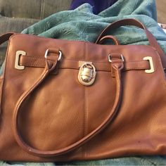 Gorgeous Caramel Colored Heavy Thick Pebble Leather Bag. Great For Any Occasion. Had Tag And Can’t Find Now, Never Used. Sturdy Leather And Very Stylish With Gold Chain Attached To Long Leather Strap And Lock. Also Has Short Handle. Beautiful Craftsmanship, Clean Inside Except For A Single Drop Light Clear Stain Near Top. Not Sure What It Is Maybe Just Water? Anyway Never Used. Scratches Near Logo On Lock From Being Stored With Other Purse When I Moved. Otherwise Very Very Clean Never Used. To H Brown Satchel With Branded Hardware For Office, Brown Office Satchel With Branded Hardware, Camel Leather Bag For Work, Camel Satchel With Gold-tone Hardware For Daily Use, Cognac Satchel Bag With Metal Hardware, Cognac Travel Bag With Silver-tone Hardware, Brown Crossbody Bag With Silver-tone Hardware, Calvin Klein Rectangular Leather Shoulder Bag, Cognac Bag With Metal Hardware For Everyday Use