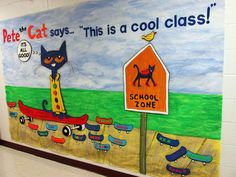 a painting on the wall of a school with cats and skateboards painted on it