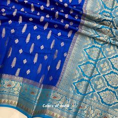 Blue saree blouse  , Georgette saree with zari borders , Semi georgette sarees for women , FREE SHIPPING This is a handwoven semi  georgette saree in  beautiful eye catching  colors . Each saree  comes with zari butis all over the body ,  floral zari borders on both the sides  and a very heavily embroidered  pallu . All the sarees come with  an unstitched blouse piece .  MATERIAL : Semi  Georgette  MEASUREMENTS : Width of the Saree :  44  Inches  Length of the Saree :  5.50 meters  Matching  Blo Blue Chanderi Pre-draped Saree With Motifs, Blue Bollywood Banarasi Silk Pre-draped Saree, Blue Katan Silk Pre-draped Saree With Zari Work, Blue Dola Silk Pre-draped Saree With Zari Weaving, Blue Semi-stitched Dola Silk Saree, Blue Pre-draped Saree With Zari Weaving, Blue Katan Silk Blouse Piece, Blue Salwar Kameez With Unstitched Blouse, Designer Blue Salwar Kameez With Unstitched Blouse