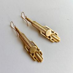 "Long lightweight 1920s earrings, silver or brass gold clean lined art deco earrings, classic Downton Abbey earrings, 925 or 14KGF ear wires These moderate to well-sized (50mm - about 2\" long), lightweight art deco detailed paddle pendants are a lovely brushed silver matte or scrubbed brass gold finish. Stamped with both classic straight lines and geometric curves reminiscent of the deco era, and the Chrysler building itself. Each pendant hangs from simple high quality sterling silver (.925) or Lined Art, 1920s Earrings, Gold Art Deco Earrings, Long Art, Downton Abbey Fashion, Bridesmaid Earrings Gold, Art Deco Gold, Earrings Classic, Long Gold Earrings