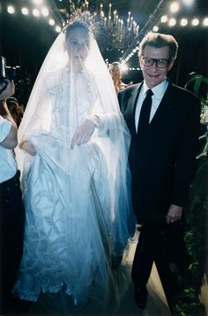 a man and woman walking down a runway