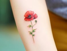 a red flower tattoo on the arm