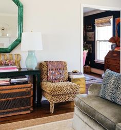 a living room filled with furniture and a mirror