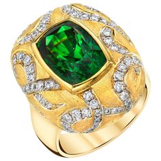 This bold ring makes a statement! The stunning 7.26 carat tsavorite garnet featured in this ring possesses a vivid, rich green color and unusually high level of clarity. Round brilliant cut diamonds set in dramatic swirls around the center bezel create a striking contrast of texture and color against the elegant matte finish. Handmade by our Master Jewelers, this one-of-a-kind ring will attract attention wherever you go! Tsavorite garnet measures 12.1 x 8.4mm, 7.26 carats Round brilliant cut dia London Topaz Ring, Sister Rings, Gold Wave Ring, Mens Skull Rings, Handmade Gold Ring, Oxidized Silver Rings, Silver Wrap Ring, Reiki Jewelry, Kids Rings