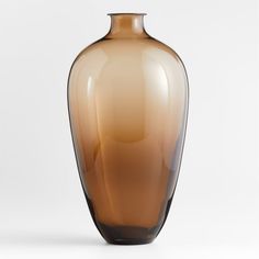 a brown vase sitting on top of a white table